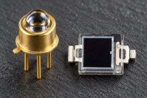 Macro view of matched TO-can and SMD optical components used in an IR photodiode emitter pair setup.