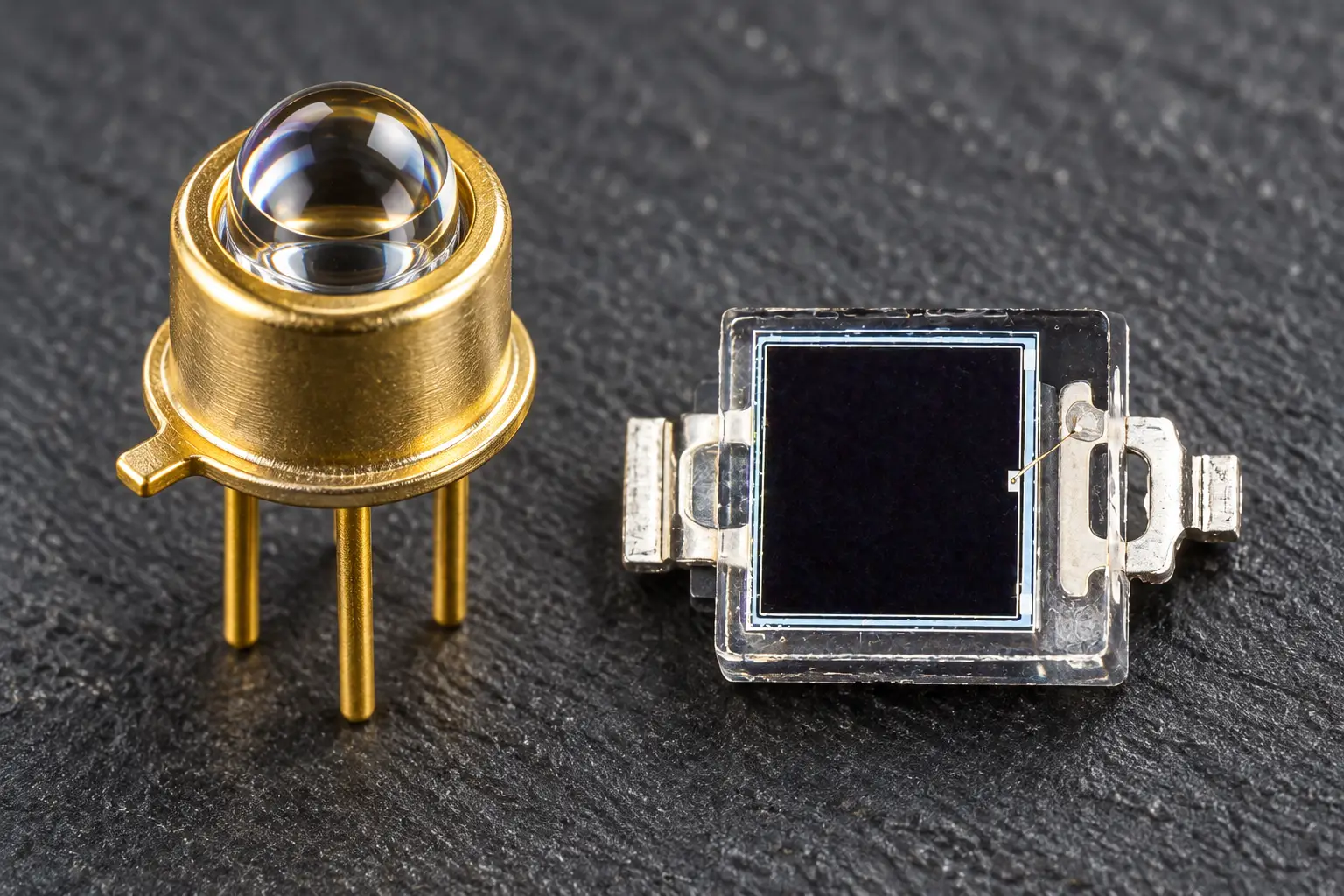 Macro view of matched TO-can and SMD optical components used in an IR photodiode emitter pair setup.